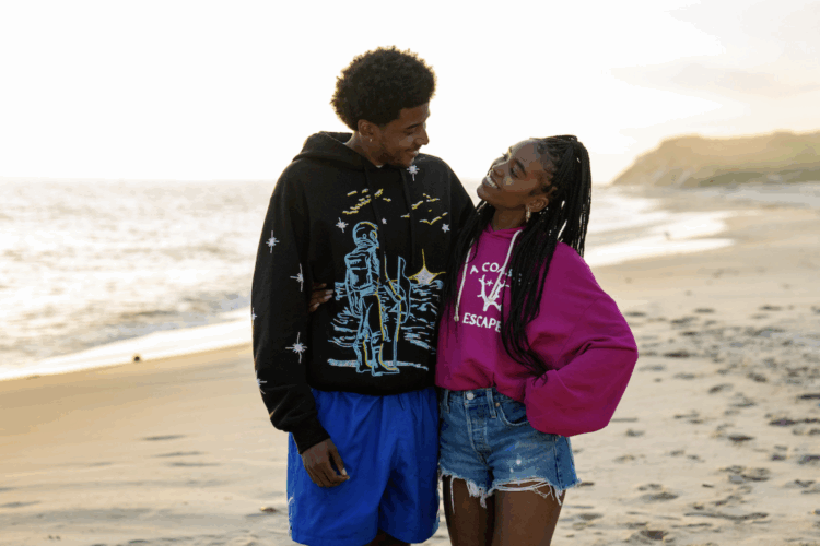 Justin and Keisha from the Netflix series Forever standing on a beach in Martha's Vineyard